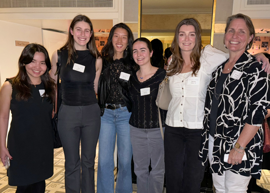 6 women standing arm in arm